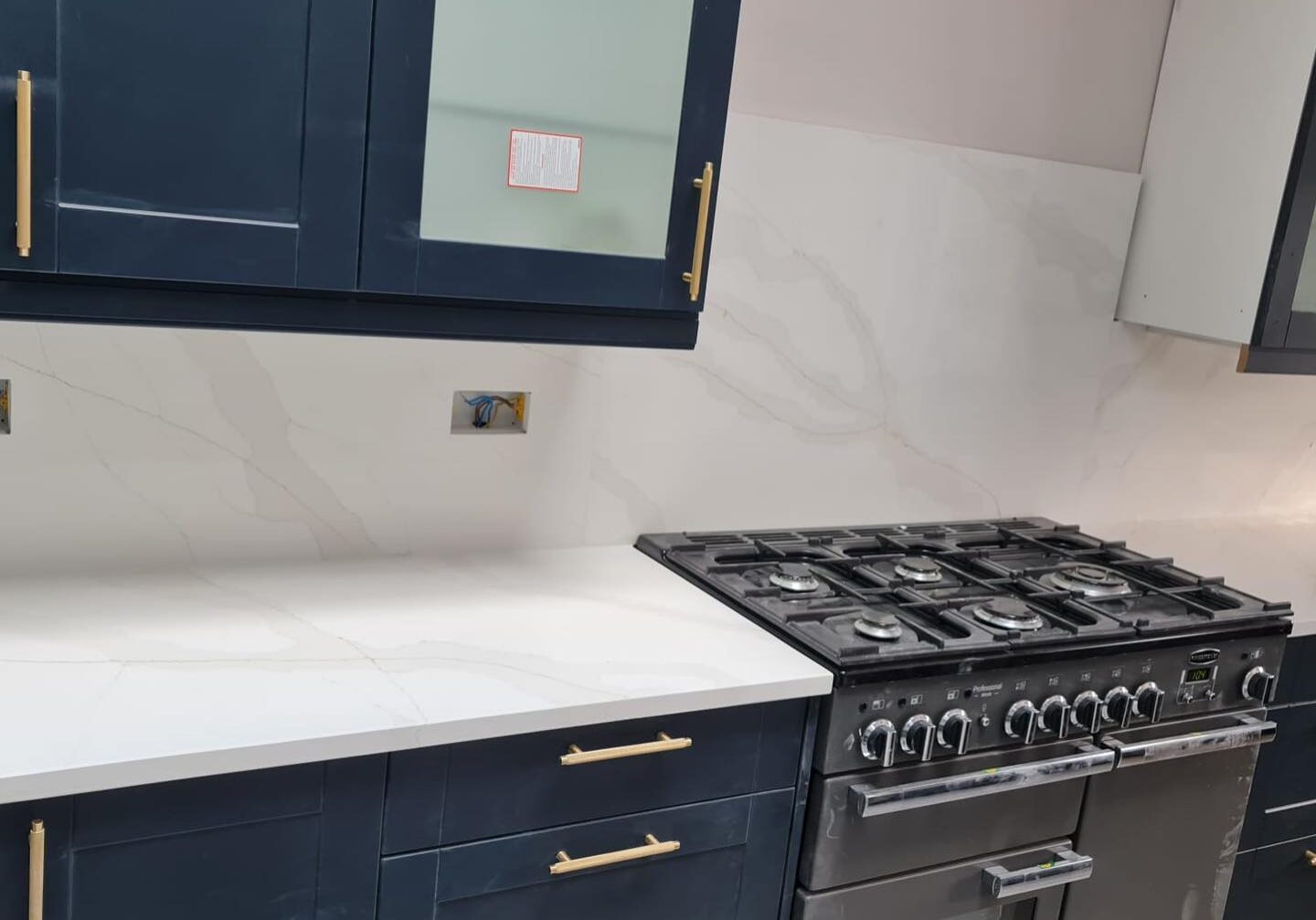 white quartz worktops with blue kitchen cupboards